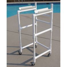 a white pool ladder next to a swimming pool