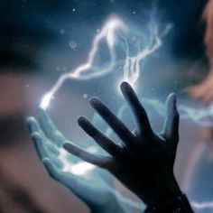 a person holding their hand up in front of a lightening background with the fingers extended out