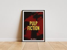 a poster with the words pulp fiction printed on it in front of a white wall