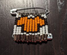 an orange and white beaded purse on a wooden table