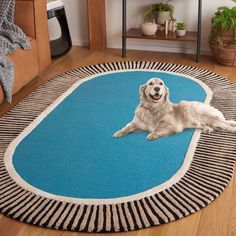 a large white dog laying on top of a blue rug