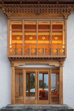 an outside view of a building with wooden windows