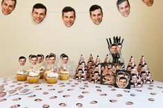 a table topped with cupcakes covered in frosting next to pictures of people