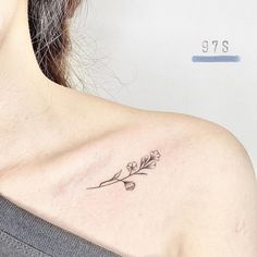 a woman with a flower tattoo on her shoulder