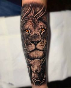 a lion and cub tattoo on the arm