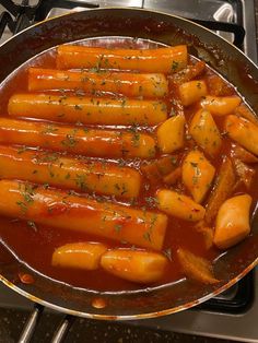 carrots are being cooked in a pan on the stove