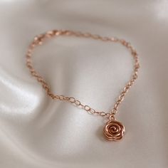 The classic English rose says it all. Whether for a special gift or a special occasion, this pretty and feminine rose gold Rose Bracelet will make a statement that everyone understands. The Rose symbolises love, promise, hope and new beginnings making it a popular choice for wedding jewellery. This dainty bracelet makes a meaningful birthday gift and is perfect for bridesmaid's jewellery. ~ DESIGN ~ This delicate chain bracelet features a rose gold plated or 14k rose gold filled Rose charm set o Gold Floral Bracelets With Rose Design, Gold Flower Bracelets With Rose Design, Gold Flower Bracelet With Rose Design, Formal Rose Gold Flower Bracelet, Elegant Rose Gold Bracelets With Flower Charm, Rose Adjustable Jewelry For Anniversary, Elegant Rose Gold Bracelet With Flower Charm, Rose Gold Bracelet With Rose Design For Gift, Delicate Adjustable Rose-colored Jewelry