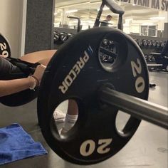 a woman is doing squats with a barbell