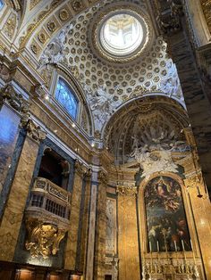 the interior of an ornate building with gold and white decor