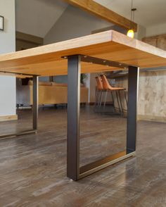 a wooden table sitting on top of a hard wood floor