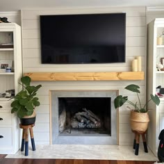 a living room with a television mounted above the fireplace