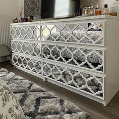 a white dresser sitting in front of a tv