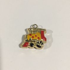 14k Yellow Gold Puffed Train Charm With Enamel. Weight: 2.2g. Length: 0.75" With Bail. Width: 0.75". In Excellent Condition. Not Marked But Acid Tested And Confirmed 14k Gold. Yellow Gold Enamel Charms For Gift, Gold Enamel Charms With Vintage Design, Gold Enamel Pendant Charms, Gold Enamel Vintage Charm, Collectible Yellow Gold Charms With Vintage Charm, Collectible Yellow Gold Charms With Vintage Design, Yellow Enamel Jewelry With Charms, Collectible Hallmarked Yellow Gold Charms, 14k Yellow Gold Charms For Collectors