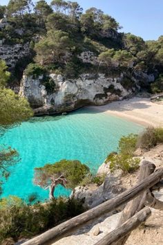 the blue water is surrounded by trees and rocks