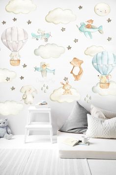 a child's bedroom with a wall mural featuring animals and hot air balloons in the sky