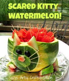 there is a watermelon carved to look like a cat