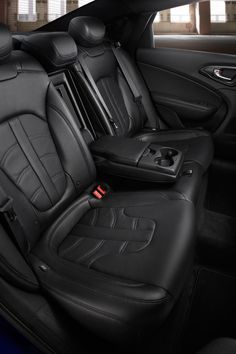 the interior of a car with black leather seats