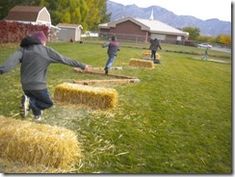 children playing in the yard with hay bales