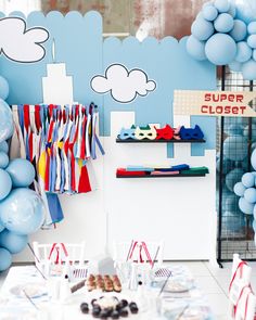 a table with balloons and cake on it