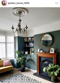 a living room filled with furniture and a fire place in front of a mirror on the wall