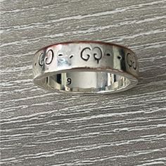 Size 9; Discoloration From Wear At The Top Of Ring As Seen In Photos. Artist Trouble Andrew Collaborated With Gucci On A Special Project By Incorporating His Art. The Final Product Is A Mix Of Two Culturesa Juxtaposition Of The Past And The Present. This Ring In Silver Is Engraved With Guccighost Motifs. 925 Sterling Silver Band Width: .2" Made In Italy Gucci Guarantees, Internally And Within Its Supply Chain, Respect For Standards Of Social & Environmental Responsibility In Line With Its Sustainability Strategy Gucci Ghost Ring, Ghost Ring, Gucci Ghost, Gucci Accessories, Sterling Silver Bands, Supply Chain, The Present, Silver Band, Sustainability