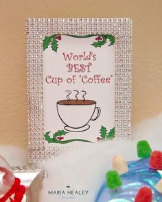 a cup of coffee sitting on top of a table next to a christmas ornament