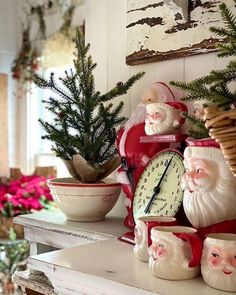 a clock and christmas decorations on a mantle