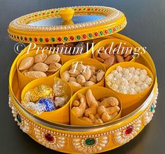 a yellow tray filled with lots of different types of nuts and other things in it