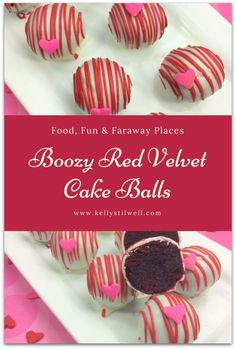 some red velvet cake balls are on a white plate with pink and red hearts around them