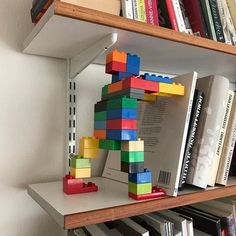 a book shelf filled with books and legos on top of eachother's shelves