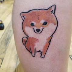 a small tattoo on the leg of a person with a fox drawn on it's side