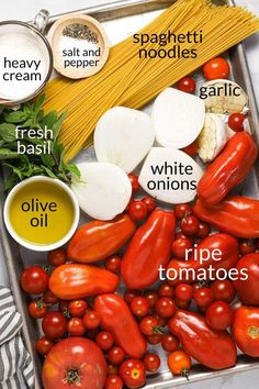 tomatoes, onions, garlic and other vegetables are labeled in the word spaghetti on a tray