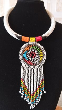 White Zulu African Beaded Necklace, African Jewelry,Tribal Necklace, Boho Necklace, Women Jewelry, Pendant Necklace, Gift For HerThis elegant statement necklace is made of Zulu fine Beads.Main Color - White.Available in different colors.For any clarification ...please send an e-mail or convo..Thank you for visiting... African Beaded Necklace, Elegant Statement Necklace, African Beads Necklace, Beautiful Beaded Jewelry, White Beaded Necklaces, Necklace African, Rope Jewelry, African Necklace, Beaded Rope