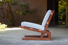 a wooden chair sitting on top of a cement floor