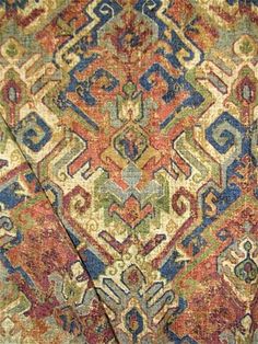 an old rug with many different colors and patterns