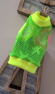 a neon green shirt hanging on a clothes rack