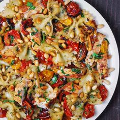 a white plate topped with pasta and vegetables