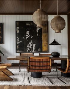 a living room filled with furniture and pictures on the wall above it's wooden table