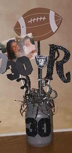 a football themed centerpiece in a vase