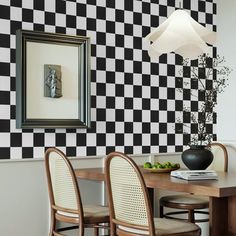 a black and white checkered wall in a dining room