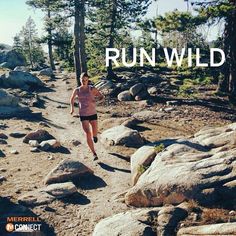 a woman running down a rocky trail with the words run wild in front of her