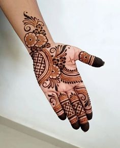 a hand with henna tattoos on it