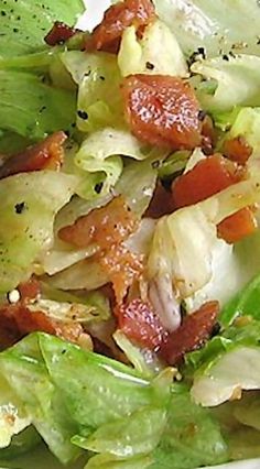 a salad with lettuce and bacon on it