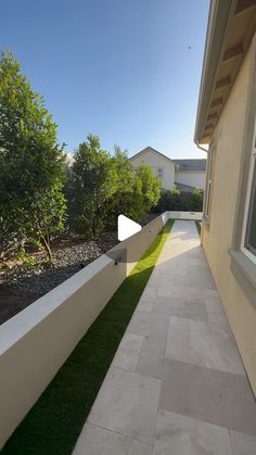 an outside view of a house with grass and bushes