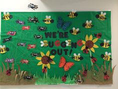 a bulletin board with bees and sunflowers in the grass that says, we're queen out