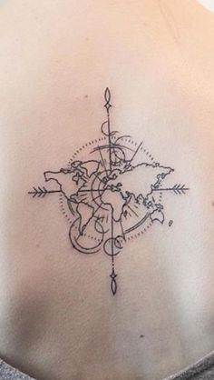 a woman's back with a compass tattoo on it