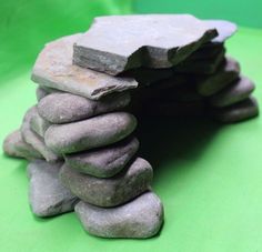 a stack of rocks sitting on top of a green surface