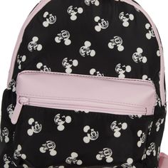 Embrace the iconic style of Minnie Mouse with this sleek black mini backpack adorned with a pattern of her classic ears. Ideal for Disney enthusiasts, it features a spacious main compartment, a convenient front zip pocket, and adjustable shoulder straps for personalized comfort. Crafted from durable nylon materials, it measures 10"W x 10.6"H x 4.25" D, ensuring both functionality and style. Easy to wipe clean, this backpack combines practicality with timeless Disney charm. Black Disney Backpack For Travel, Casual Black Backpack For Disney Trips, Black Minnie Mouse Backpack For Back To School, Black Minnie Mouse Bag For Back To School, Black Minnie Mouse Standard Backpack, Back To School Minnie Mouse Black Backpack, Black Mickey Mouse Backpack, Black Minnie Mouse Backpack For Everyday Use, Minnie Mouse Travel Backpack