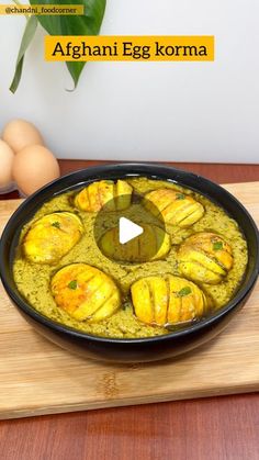 the dish is prepared and ready to be eaten on the cutting board with eggs in the background