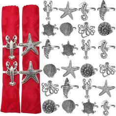 two red napkins with silver sea animals and starfish on them, one in the middle